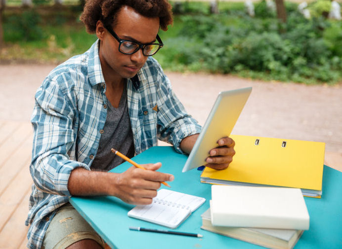 man outside taking notes